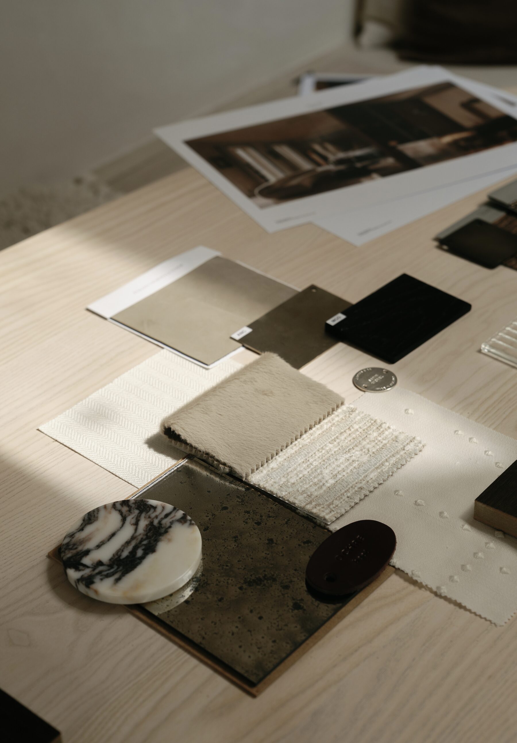 Materials, fabric and finish samples laid out on the studio table