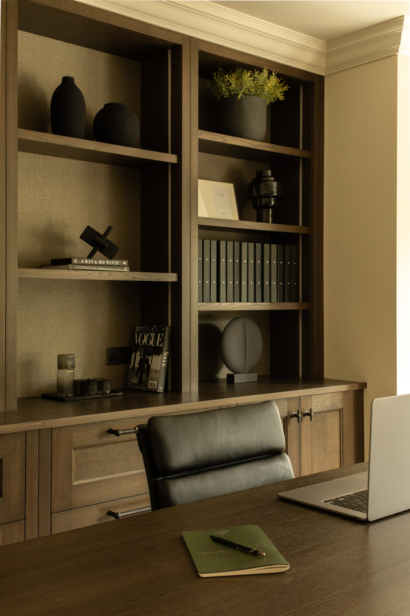 Built-in study joinery with shelving, desk and leather chair