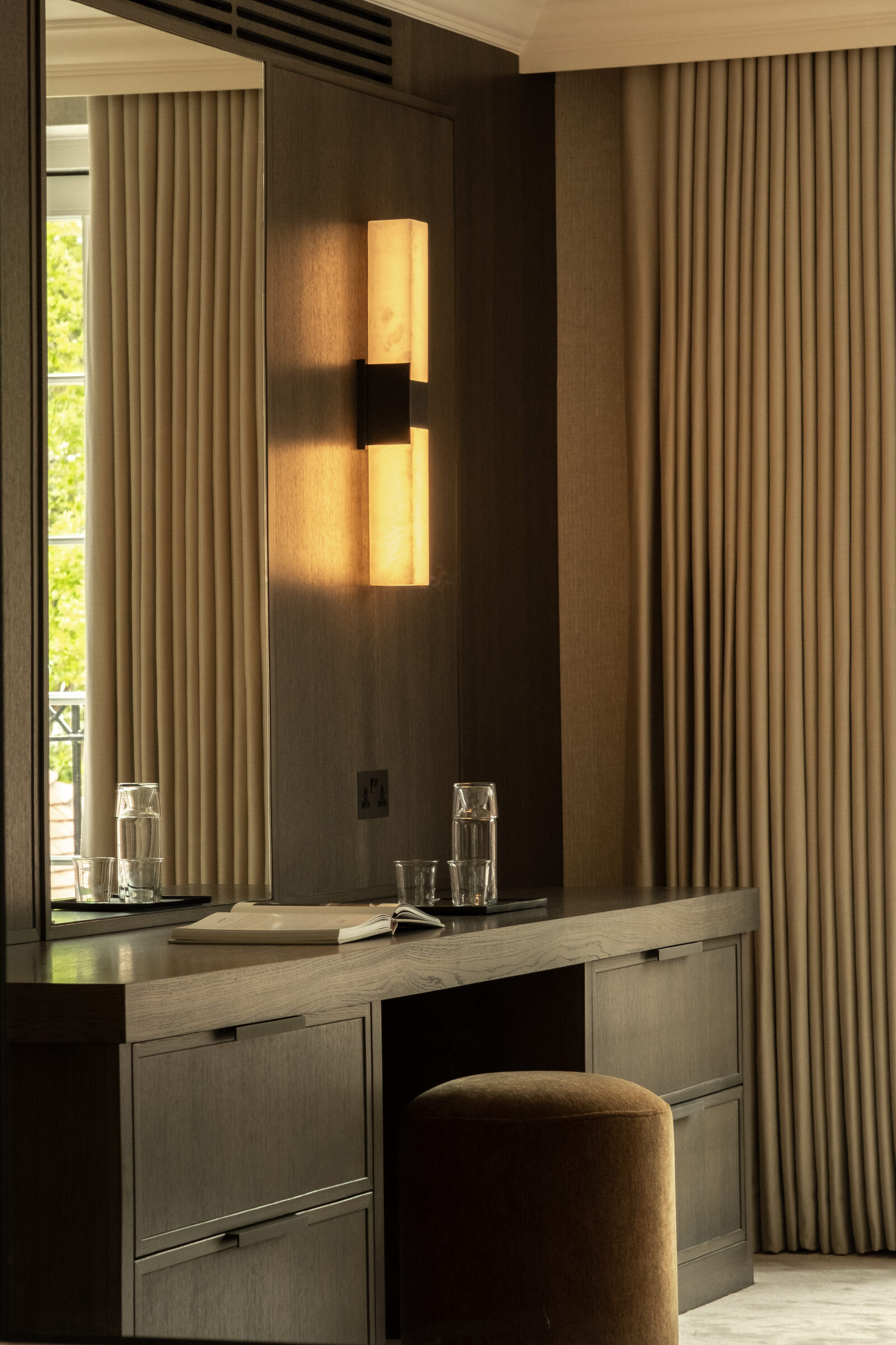 Dressing table with alabaster wall light and upholstered stool